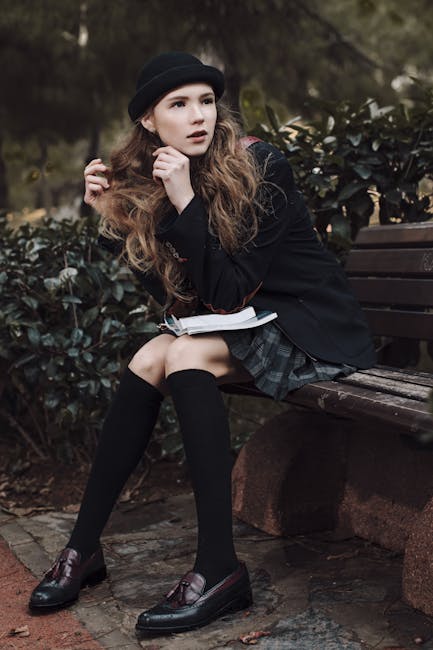 pexels-photo-4355863-4355863 Stylish woman in dark academia attire seated on a park bench with thoughtful look, surrounded by nature.